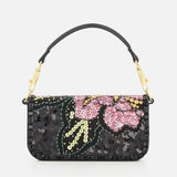 Make a statement with the VALENTINO GARAVANI Loco Small Shoulder Bag—a black handbag featuring a short handle, adorned with pink, yellow, and green sequin floral patterns and gold-tone hardware. This sparkling sequined minaudière is the perfect evening bag for adding a touch of glamour to any outfit.