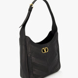 VALENTINO GARAVANI Loise Medium Leather Hobo Bag in black nappa leather, featuring a wide strap, gold buckle, and signature gold V logo on the front, displayed against a white background.