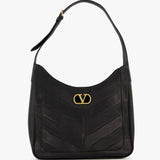 The Loise Medium Leather Hobo Bag by VALENTINO GARAVANI is crafted from luxurious black nappa leather and features a gold V logo on the front, a single shoulder strap, and elegant chevron-patterned stitching.