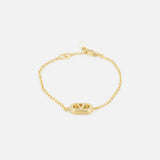 The VALENTINO GARAVANI Ovalette Pearl Bracelet features a gold-tone chain with an oval charm and triangular detail, plus a Swarovski pearl accent near the clasp, shown against a white background.