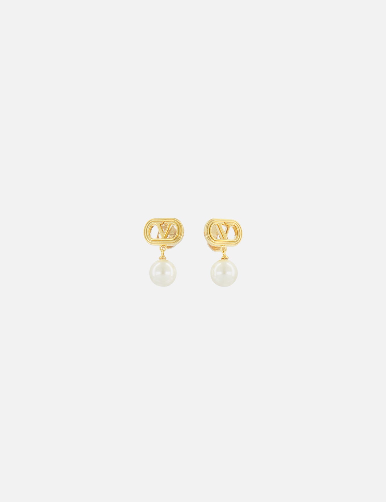 The VALENTINO GARAVANI Ovalette Logo Pearl Earrings feature gold-tone interlocking V logos with a single round white pearl drop, shown on a plain white background.