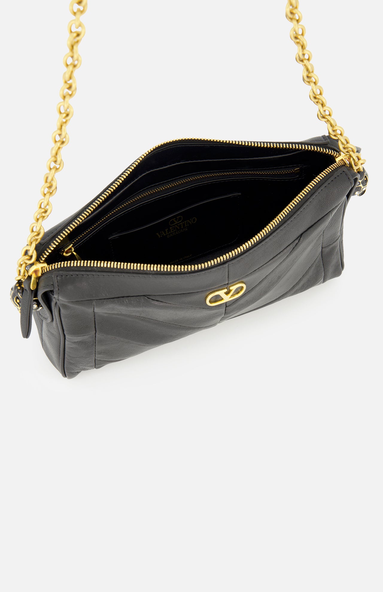 A black leather Valentino Garavani Panthea Small Shoulder Bag with a chevron pattern, a gold chain strap, an open zippered top, and a gold metal logo emblem on the front.