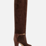 The VALENTINO GARAVANI Pattie Suede Ankle Strap Boot is a tall brown suede and leather equestrian-style boot featuring a rounded toe and an ankle strap with a small buckle, shown against a white background.
