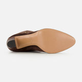 The VALENTINO GARAVANI Pattie Suede Ankle Strap Boot is pictured from the bottom, showcasing its smooth tan sole and pointed toe against a white background, echoing the refined elegance of tall suede boots.