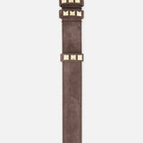 The VALENTINO GARAVANI Rockstud Belt H. 30 is a dark brown suede belt with a gold rectangular buckle and gold square studs near the buckle and along the strap, shown against a white background.