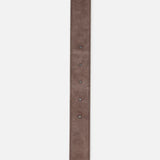 A close-up of the VALENTINO GARAVANI Rockstud Belt H. 30 in dark brown suede highlights five adjustment holes and stitched edges, set against a white background.