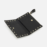 The VALENTINO GARAVANI Rockstud Coin Purse is crafted in black leather and features signature gold rockstuds along the edges. When open, it reveals organized card slots, a zippered coin compartment, and a snap-button pocket. A small tab with a snap button is positioned at the upper right corner for secure closure.