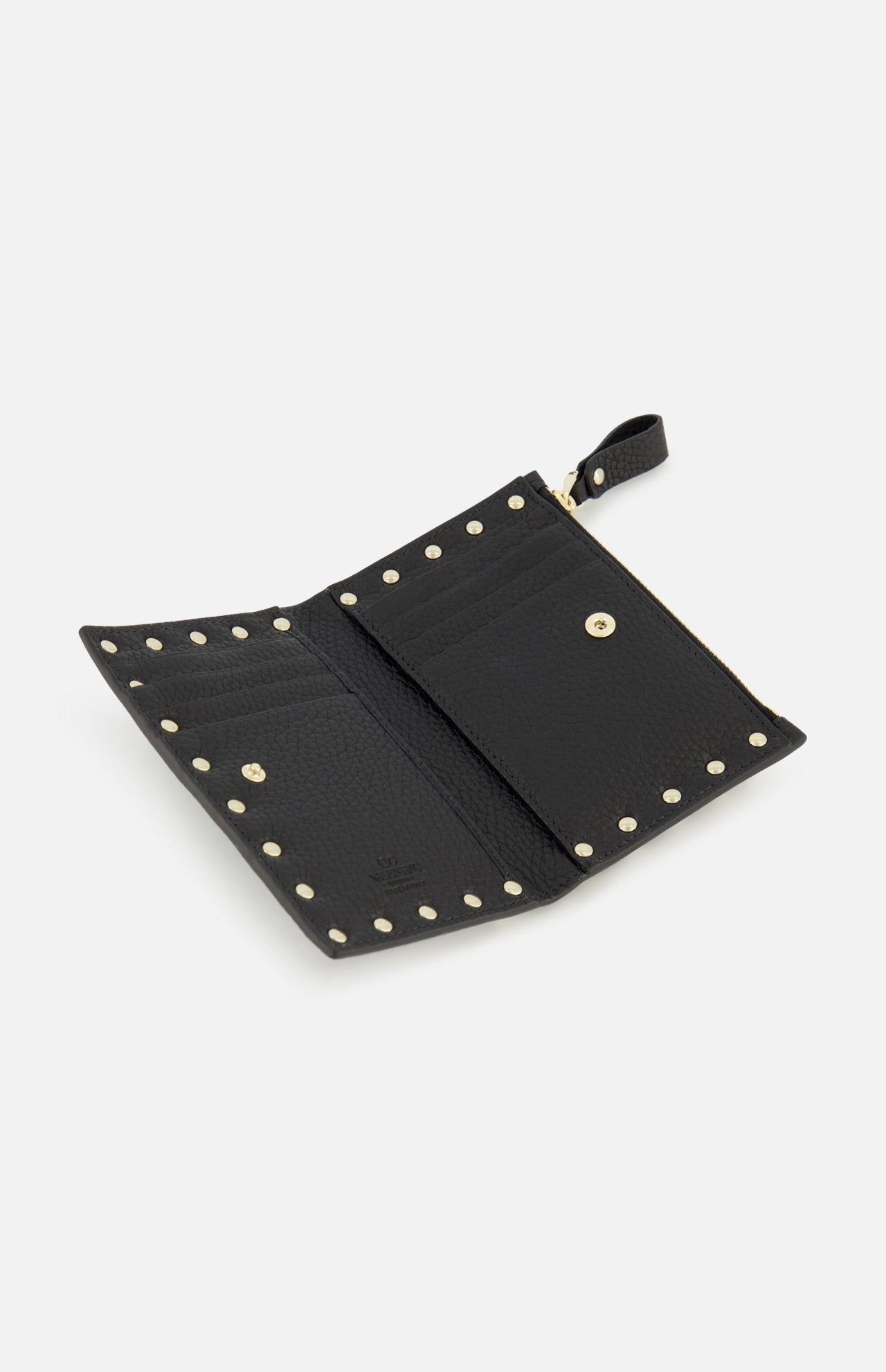 The VALENTINO GARAVANI Rockstud Coin Purse is crafted in black leather and features signature gold rockstuds along the edges. When open, it reveals organized card slots, a zippered coin compartment, and a snap-button pocket. A small tab with a snap button is positioned at the upper right corner for secure closure.