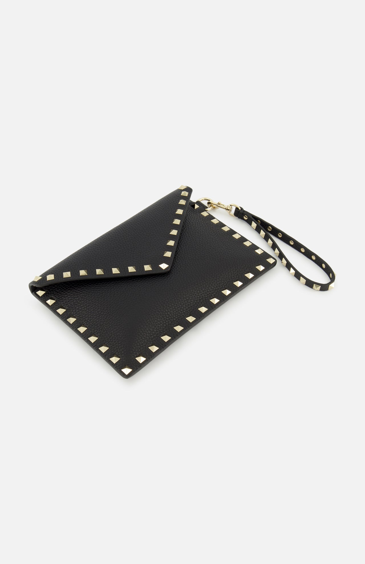 The VALENTINO GARAVANI Rockstud Medium Flat Pouch is a black envelope clutch crafted in textured leather, adorned with gold pyramid rockstuds along the edges and featuring a matching studded wrist strap, displayed on a white background.