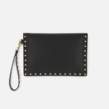 The Rockstud Medium Flat Pouch by VALENTINO GARAVANI is a black leather clutch with an envelope silhouette, featuring gold rockstuds outlining the edges and a coordinating studded wrist strap, displayed on a white background.