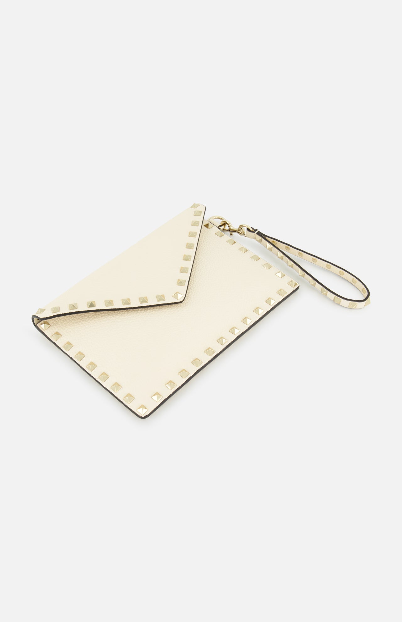 The VALENTINO GARAVANI Rockstud Medium Flat Pouch is an ivory clutch with a chic envelope design, adorned with signature gold rockstuds along the edges and completed with a matching wrist strap, displayed on a white background.