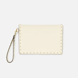 The Rockstud Medium Flat Pouch by VALENTINO GARAVANI is a cream-colored wristlet designed in an elegant envelope style, accented with gold rockstuds along the edges and finished with a matching detachable wrist strap, shown against a plain white background.