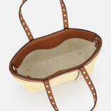 Top view of VALENTINO GARAVANI Rockstud Mini Tote Bag, featuring raffia and brown leather with gold rockstud handles, beige fabric lining, and an interior zipper pocket.