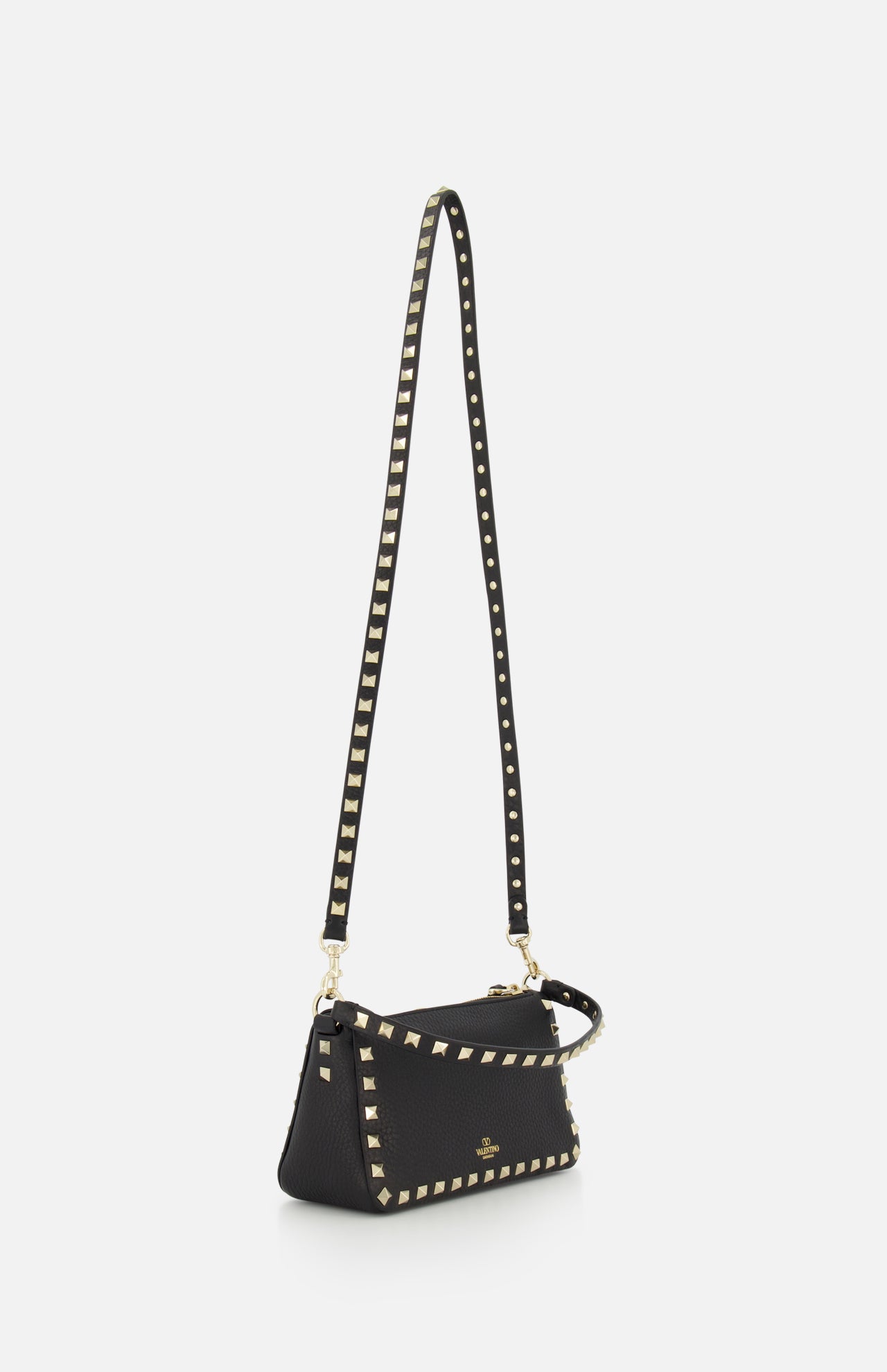 The VALENTINO GARAVANI Rockstud Small Shoulder Bag is a black leather shoulder bag with gold square studs along the edges and a long removable strap, shown against a white background.