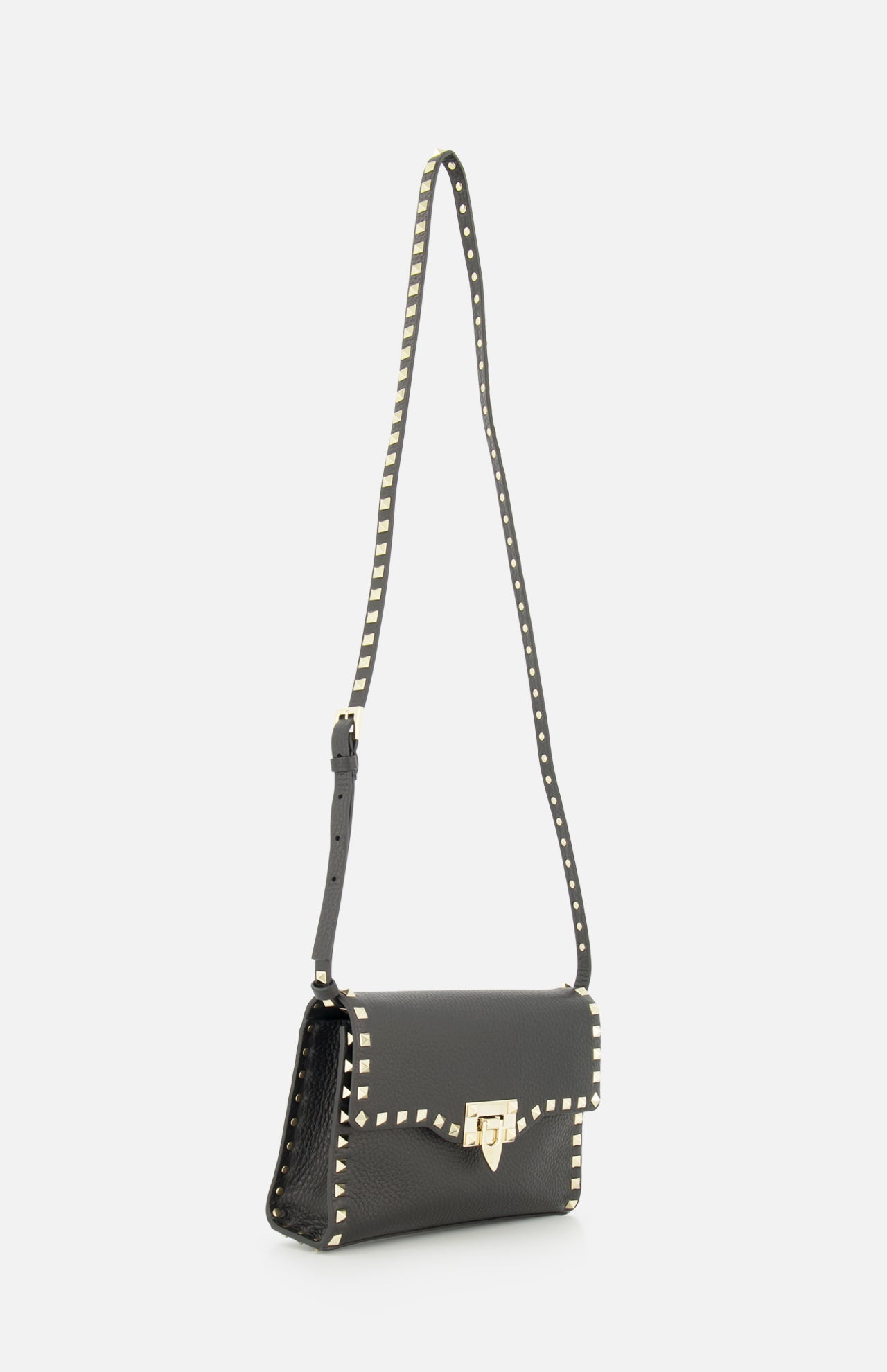 The VALENTINO GARAVANI Rockstud Small Shoulder Bag, crafted from black Italian leather, features a gold clasp and gold pyramid studs outlining the edges and strap. This striking handbag is showcased against a plain white background.