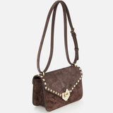 The VALENTINO GARAVANI Rockstud Small Suede Shoulder Bag, in brown, features a rockstud-trimmed flap, gold heart-shaped clasp, and adjustable suede strap. Displayed on a plain white background.