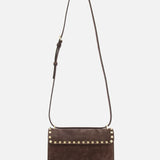 The VALENTINO GARAVANI Rockstud Small Suede Shoulder Bag features brown suede, a flap closure, signature rockstud trim along the edge, and an adjustable strap, shown against a white background.