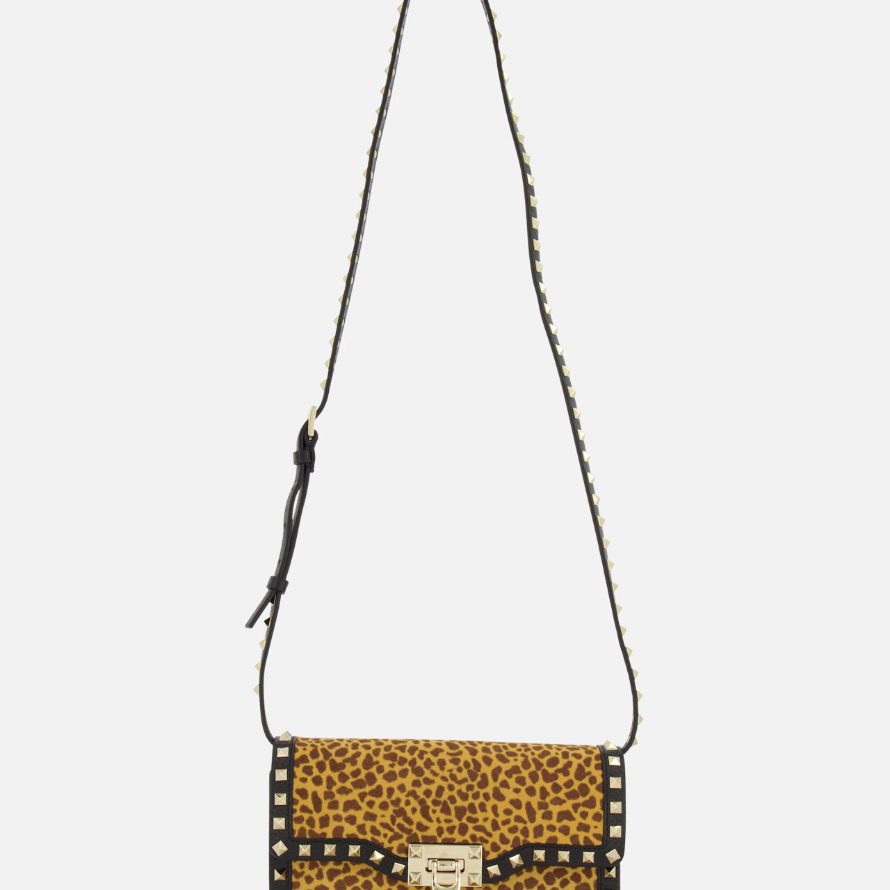 The VALENTINO GARAVANI Rockstud Small Leopard Print Shoulder Bag features pony-effect calfskin with black trim, a silver clasp, and a rockstud-adorned black strap. Shown against a plain white background.