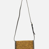 The Rockstud Small Leopard Print Shoulder Bag by VALENTINO GARAVANI features a rectangular shape, pony-effect calfskin flap, black trim, gold rockstuds on the edges, and a long black strap embellished with small gold studs.