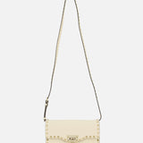 Introducing the Rockstud Small Shoulder Bag by VALENTINO GARAVANI, a refined cream-colored rectangular accessory crafted in elegant ivory. This sophisticated handbag is detailed with signature gold pyramid studs outlining its flap closure and extends to the adjustable studded strap, elevating its modern appeal. Shot against a plain white background, this versatile piece seamlessly combines chic styling with timeless charm.