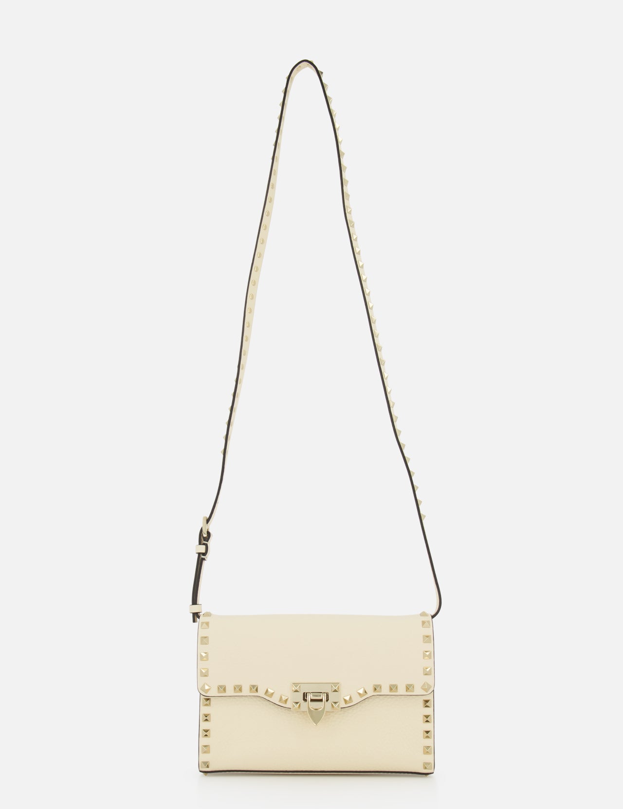 Introducing the Rockstud Small Shoulder Bag by VALENTINO GARAVANI, a refined cream-colored rectangular accessory crafted in elegant ivory. This sophisticated handbag is detailed with signature gold pyramid studs outlining its flap closure and extends to the adjustable studded strap, elevating its modern appeal. Shot against a plain white background, this versatile piece seamlessly combines chic styling with timeless charm.