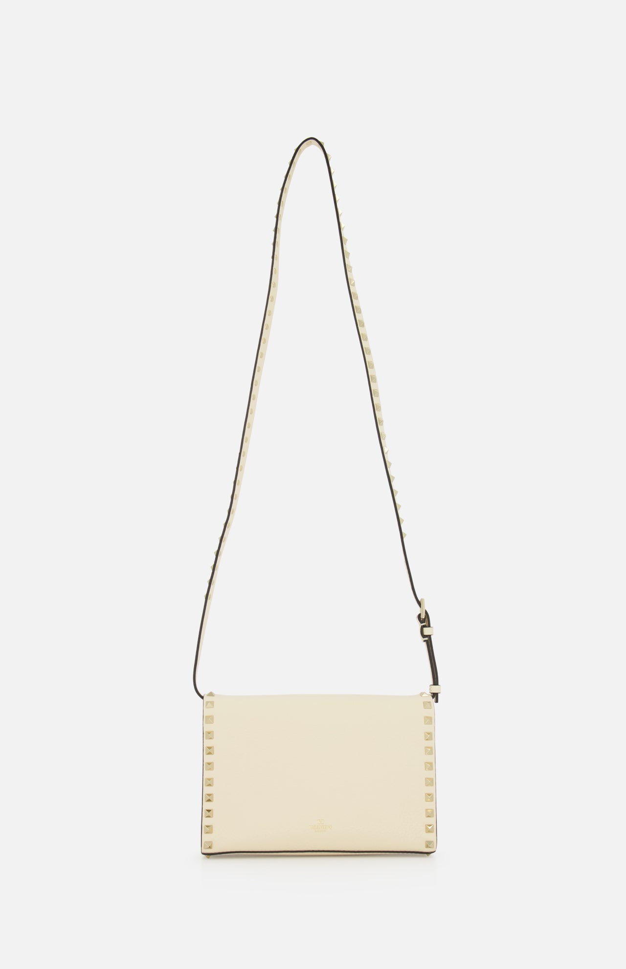 The VALENTINO GARAVANI Rockstud Small Shoulder Bag, crafted in cream-colored leather with a long adjustable strap and small square stud details along the edges, is elegantly displayed on a white background.