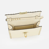 The VALENTINO GARAVANI Rockstud Small Shoulder Bag in beige showcases a flap opening that reveals its interior pocket and striking gold-tone hardware. This elegant leather crossbody bag features the signature Rockstud detailing along the edges and a structured rectangular silhouette, making it a refined accessory for any occasion.