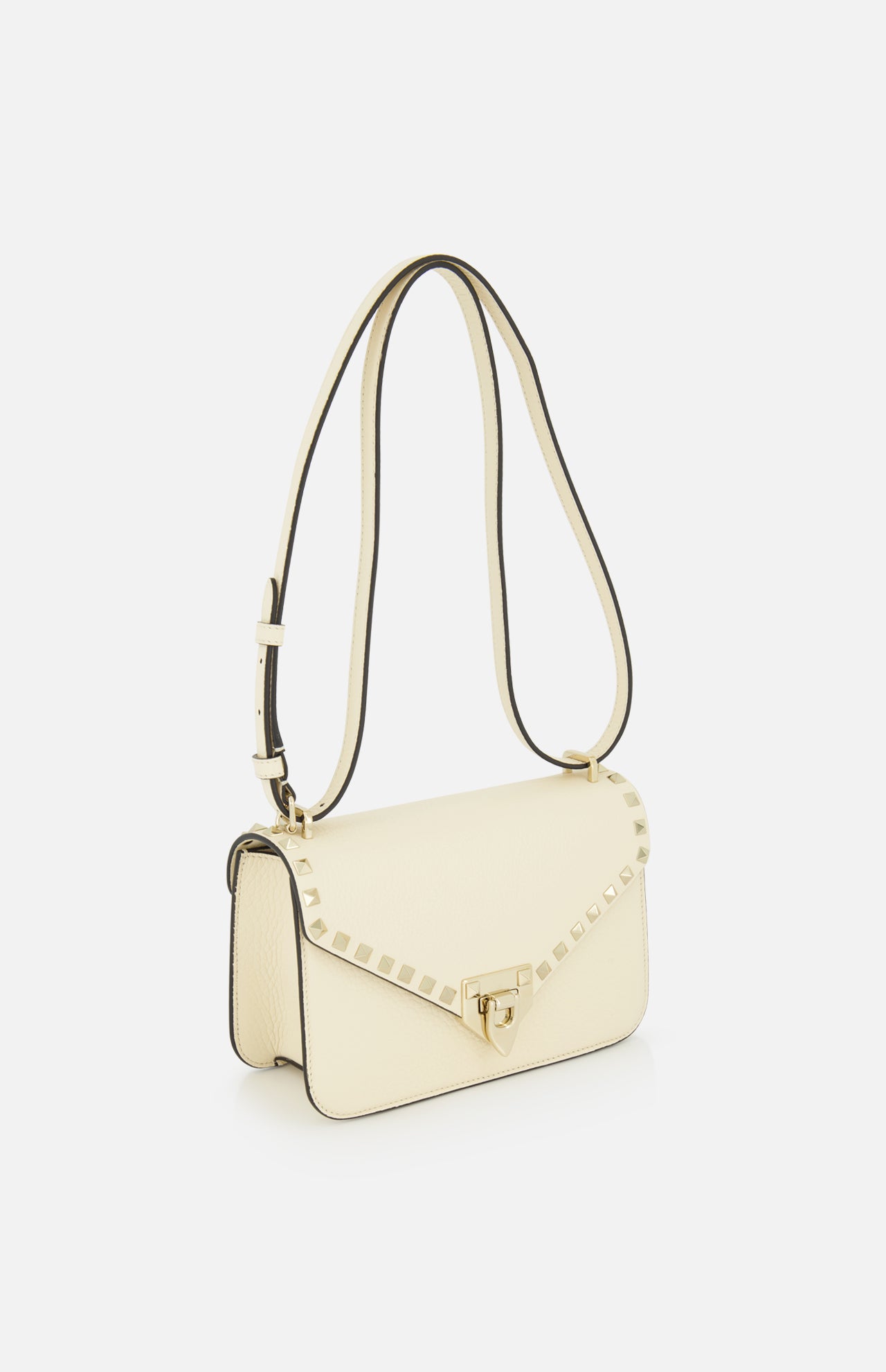 Valentino Garavani Rockstud Small Shoulder Bag in ivory leather featuring gold-tone pyramid studs along the flap and a turn-lock closure.