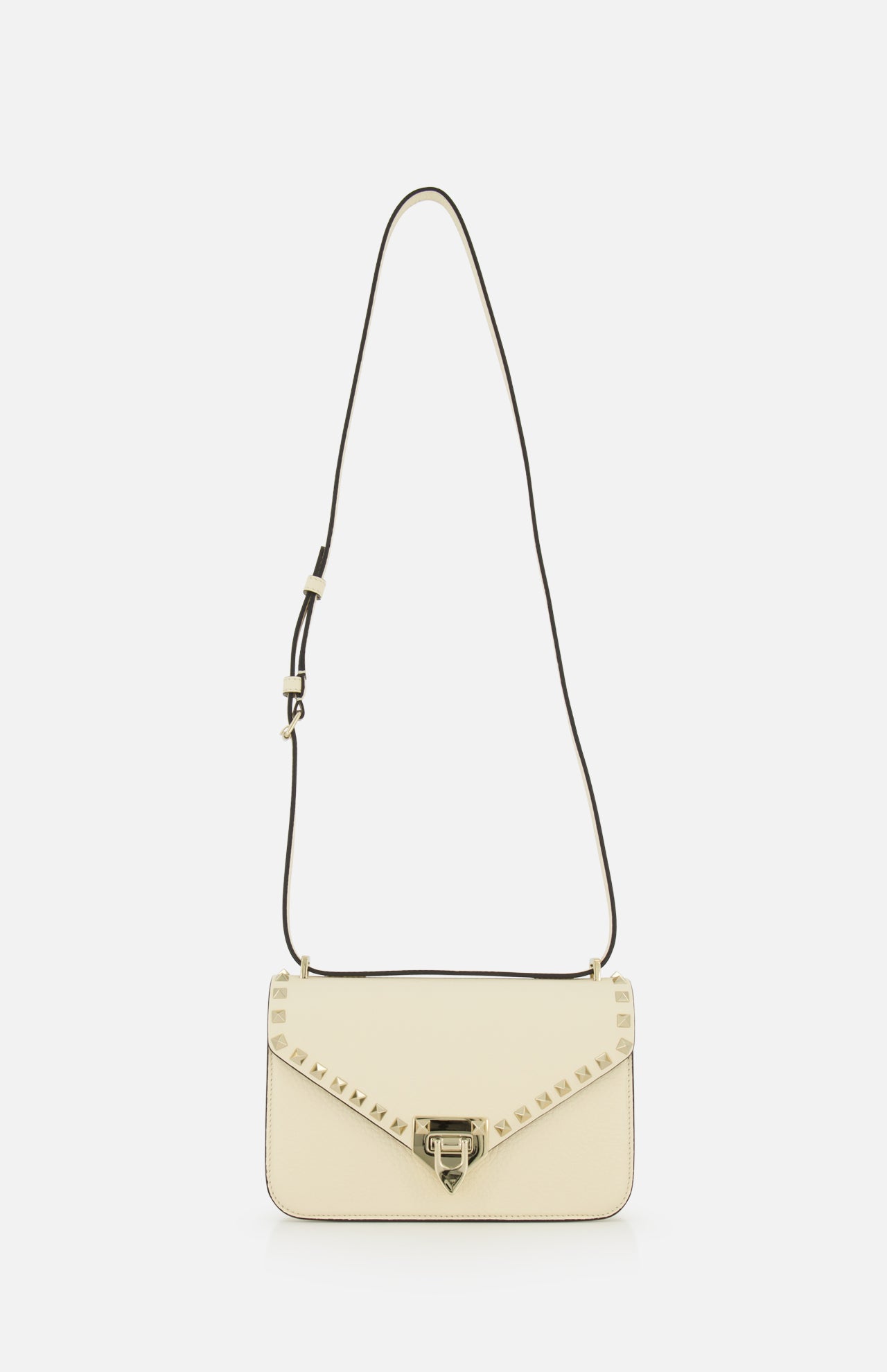 Valentino Garavani Rockstud Small Shoulder Bag in ivory leather with a long strap, gold-tone pyramid studs along the front flap, and a metallic clasp.