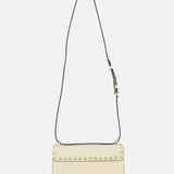 Valentino Garavani Rockstud Small Shoulder Bag in off-white ivory leather with a thin adjustable strap and a row of gold pyramid studs along the front flap.