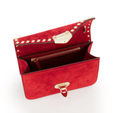 The VALENTINO GARAVANI Rockstud Small Suede Shoulder Bag features lipstick red suede, gold hardware, signature rockstud trim, a zippered pocket, and a spacious main compartment, shown against a white background.