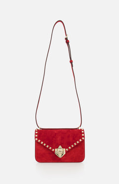 The VALENTINO GARAVANI Rockstud Small Suede Shoulder Bag in lipstick red features gold-tone rockstud trim, a gold clasp, and an adjustable brown leather strap, shown on a plain white background.