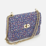 The VALENTINO GARAVANI Rockstud Spike Medium Shoulder Bag is a small, rectangular, multicolored tweed bag featuring a gold turn-lock clasp and a long gold chain strap, displayed on a white background—perfect as an elegant shoulder bag for any occasion.