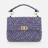 The Rockstud Spike Medium Shoulder Bag by VALENTINO GARAVANI is crafted from multicolored tweed fabric, featuring a short handle and a gold-tone rectangular clasp on the front flap, and is designed to double as a chic shoulder bag.