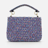 The VALENTINO GARAVANI Rockstud Spike Medium Shoulder Bag, crafted from blue, pink, and white textured tweed and adorned with subtle rockstud spikes, features a short top handle and is showcased against a plain white background.
