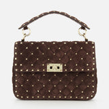 The VALENTINO GARAVANI Rockstud Spike Medium Shoulder Bag features dark brown quilted suede adorned with signature gold micro rockstuds, a top handle, and a gold rectangular clasp on the front flap.