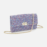 The VALENTINO GARAVANI Rockstud Spike Shoulder Bag, featuring a small rectangular silhouette with a multicolored tweed pattern, gold clasp, and removable chain strap, is elegantly displayed against a white background.