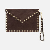 The VALENTINO GARAVANI Rockstud Suede Medium Flat Pouch, crafted in a rich dark brown suede, features signature gold pyramid studs outlining the envelope silhouette and includes a detachable matching wrist strap. Set against a plain white background, this designer wristlet is both timeless and eye-catching—a sophisticated rockstud-trim clutch perfect for any occasion.