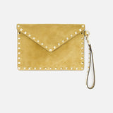 The VALENTINO GARAVANI Rockstud Suede Medium Flat Pouch is a tan suede clutch accented with signature gold-tone pyramid studs along the edges and features a detachable wrist strap, shown against a white background.