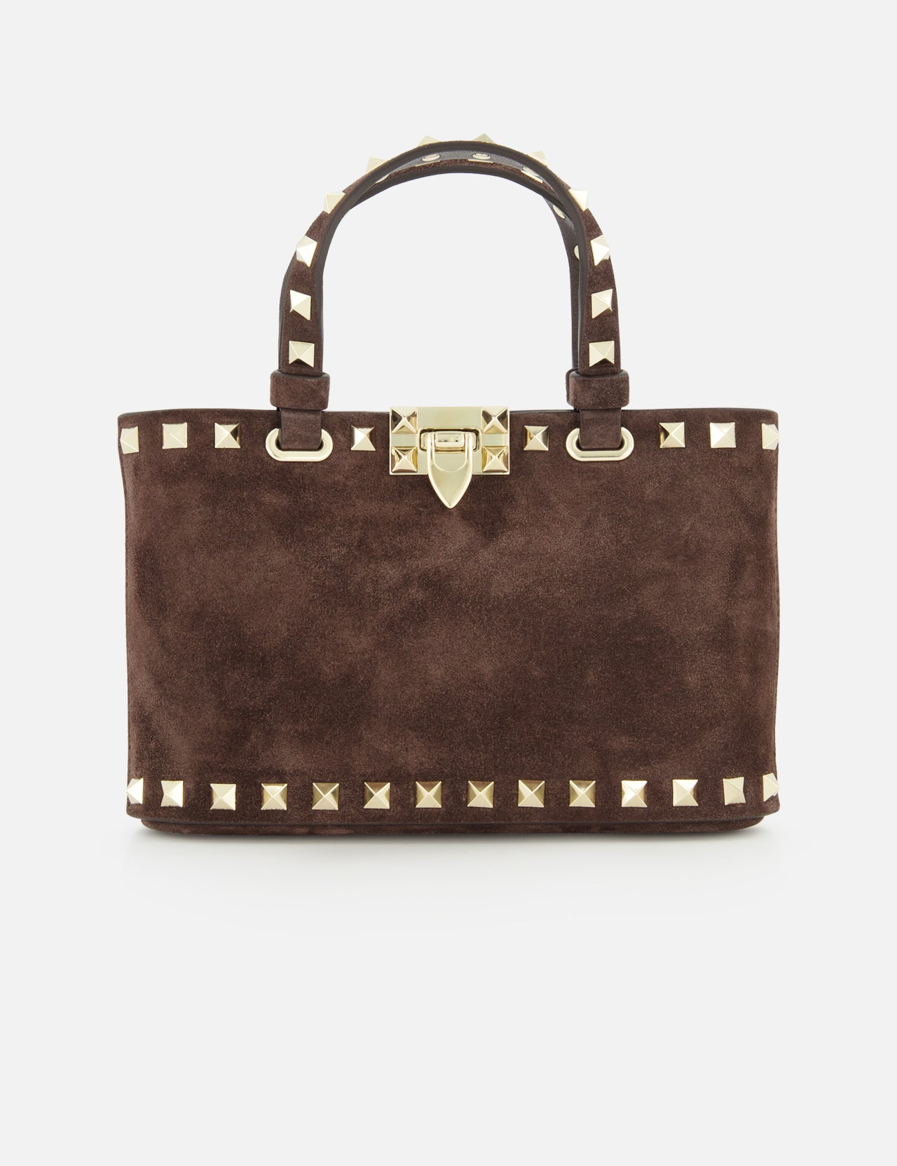 The Rockstud Suede Mini Bag by VALENTINO GARAVANI is a rectangular, dark chocolate brown suede mini bag, embellished with gold pyramid studs and a matching gold clasp. It features two handles accented with gold studs and includes a removable chain strap, all elegantly displayed on a white background.