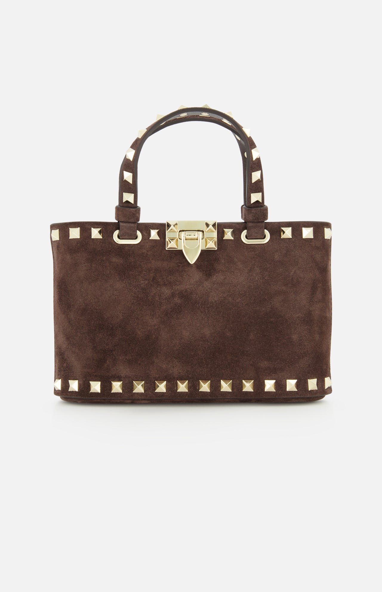 The Rockstud Suede Mini Bag by VALENTINO GARAVANI is a rectangular, dark chocolate brown suede mini bag, embellished with gold pyramid studs and a matching gold clasp. It features two handles accented with gold studs and includes a removable chain strap, all elegantly displayed on a white background.