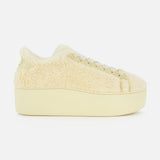 The VALENTINO GARAVANI Royco Shearling Platform Sneaker, featuring a beige hue and a plush, shearling-like upper, is displayed from the side against a plain white background.