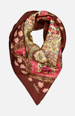 The Shawls Floral Foulard Scarf by VALENTINO GARAVANI features a rich brown border and intricate floral prints in pink, red, yellow, and green—an elegant designer accessory that adds a refined touch to any ensemble.