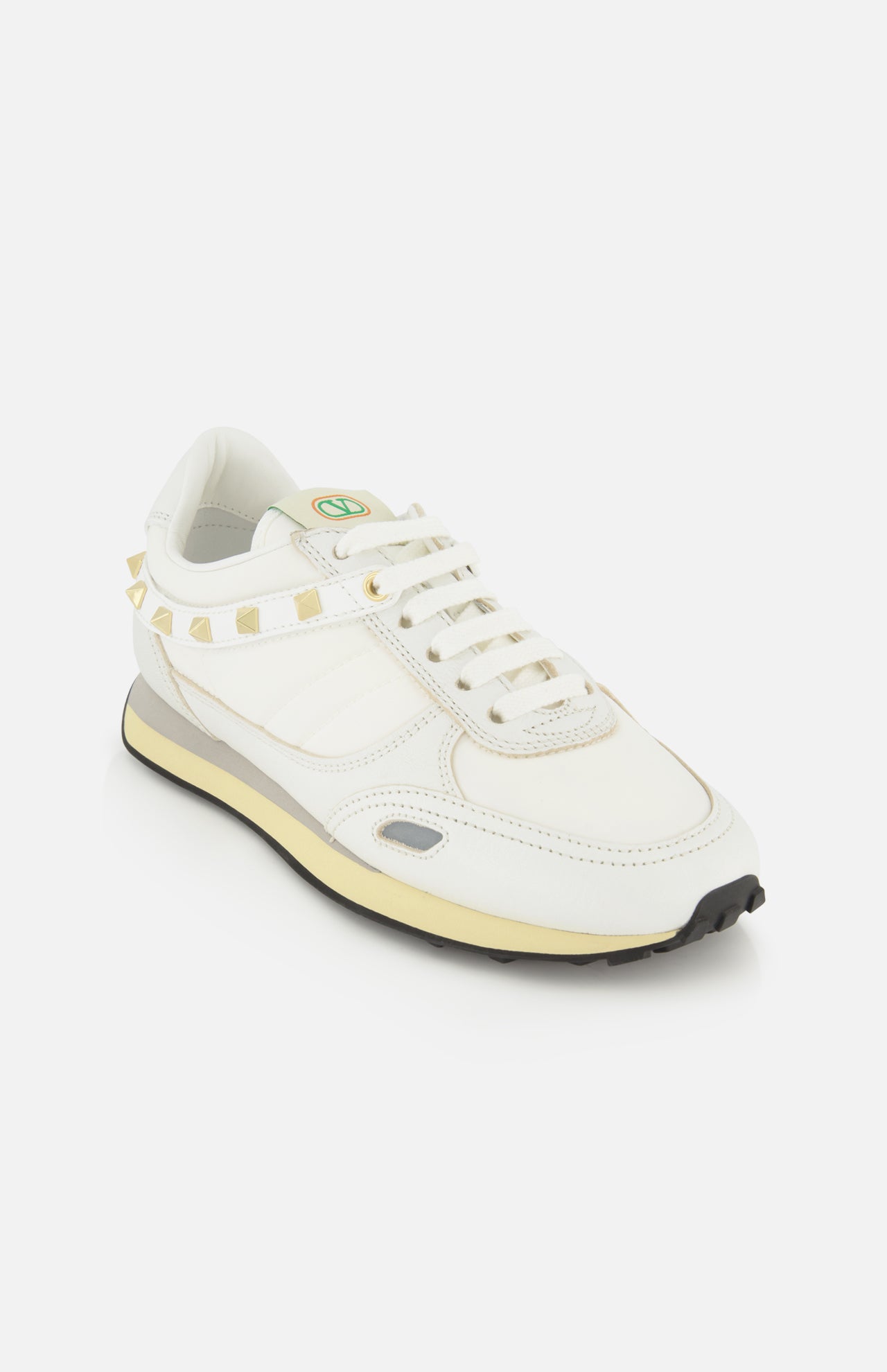White Valentino Garavani Stud Up low-top sneakers featuring a row of rockstud trims around the heel and a two-tone midsole.
