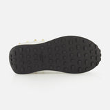 Black rubber sole of a Valentino Garavani Stud Up Sneaker, featuring a low-top silhouette and a grid tread pattern seen from below.