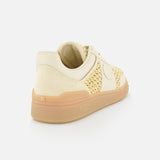 The VALENTINO GARAVANI Upvillage Raffia Sneaker features cream and beige hues, woven raffia side panels, a suede heel, rubber sole, and an embossed Valentino logo on the heel—shown angled to display the side and back on a white background.