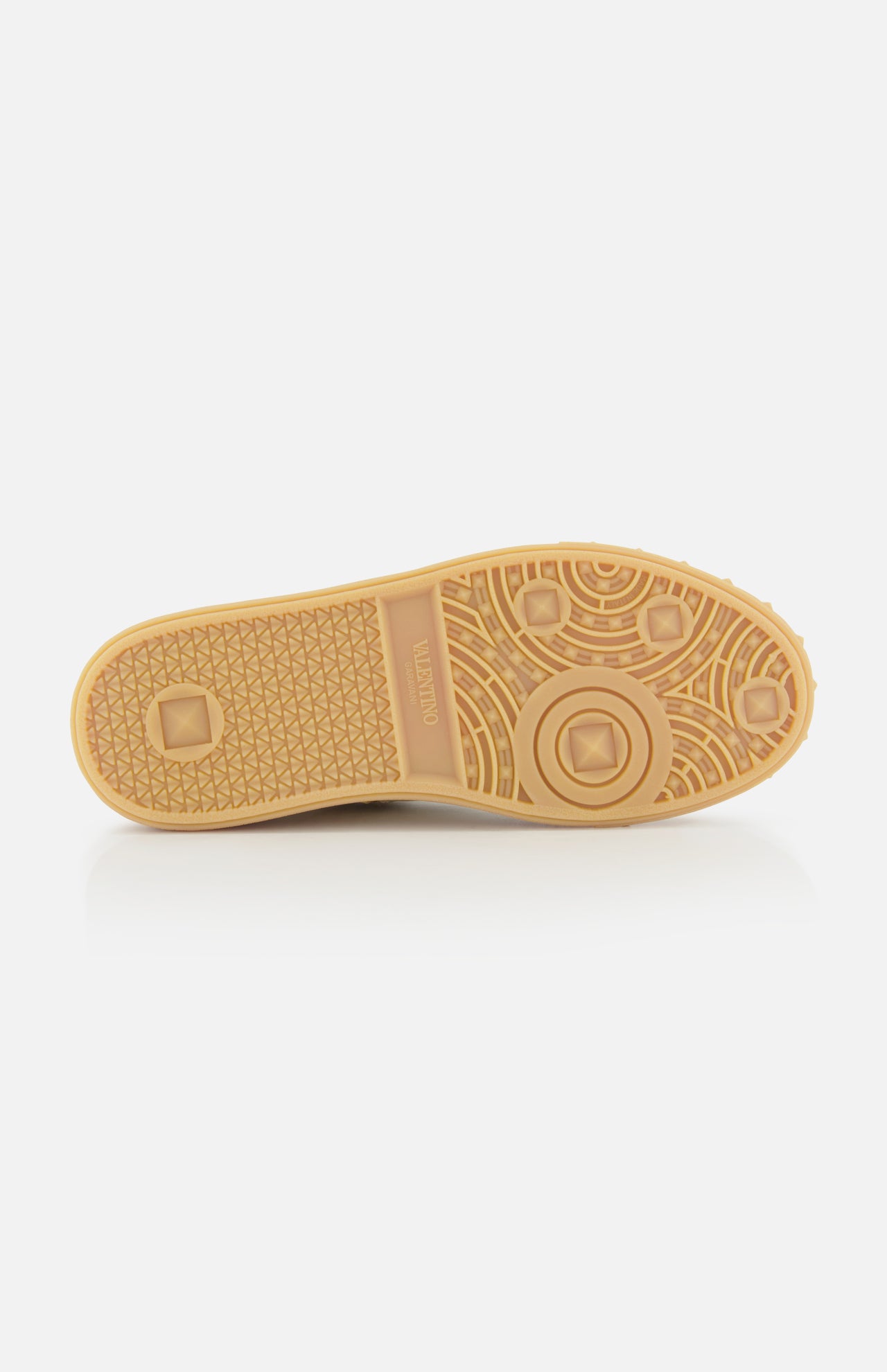 A light brown designer sole by VALENTINO GARAVANI, with geometric tread and the Valentino name embossed, provides traction for Upvillage Raffia Sneakers. Features include circular, diamond, and grid patterns.