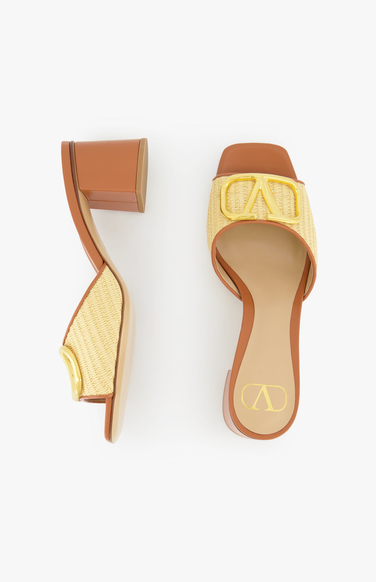 The VALENTINO GARAVANI V Logo Signature Block Heel Slide Sandal features tan and yellow woven raffia uppers, block heels, and gold decorative buckles, shown on a white background.