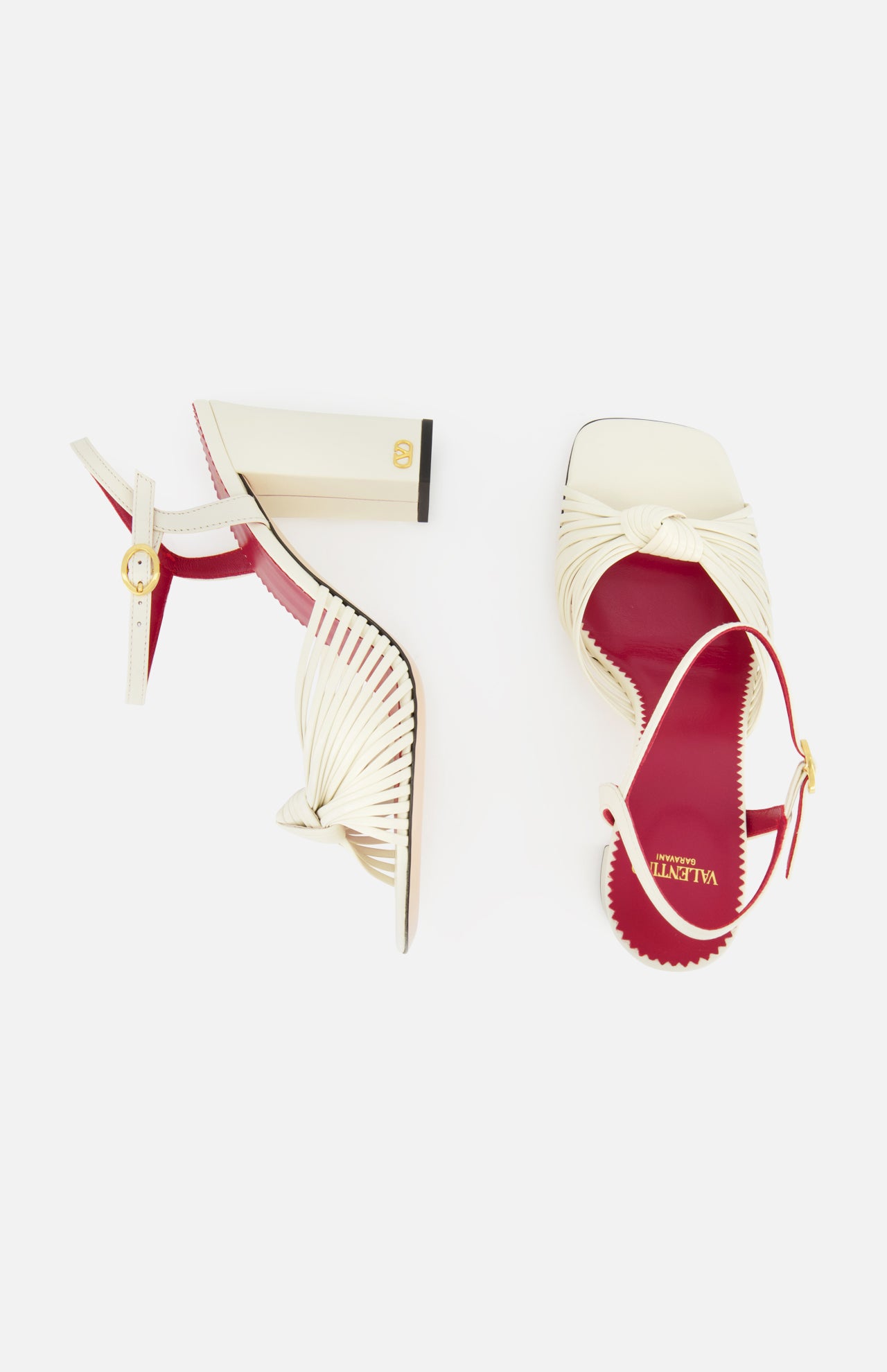 The Valentino Garavani Annet T.90 Sandal by VALENTINO GARAVANI features cream pleated leather, open toes, red insoles, an ivory heel, and a leather ankle strap. One sandal is upright; the other is shown from above on a white background.