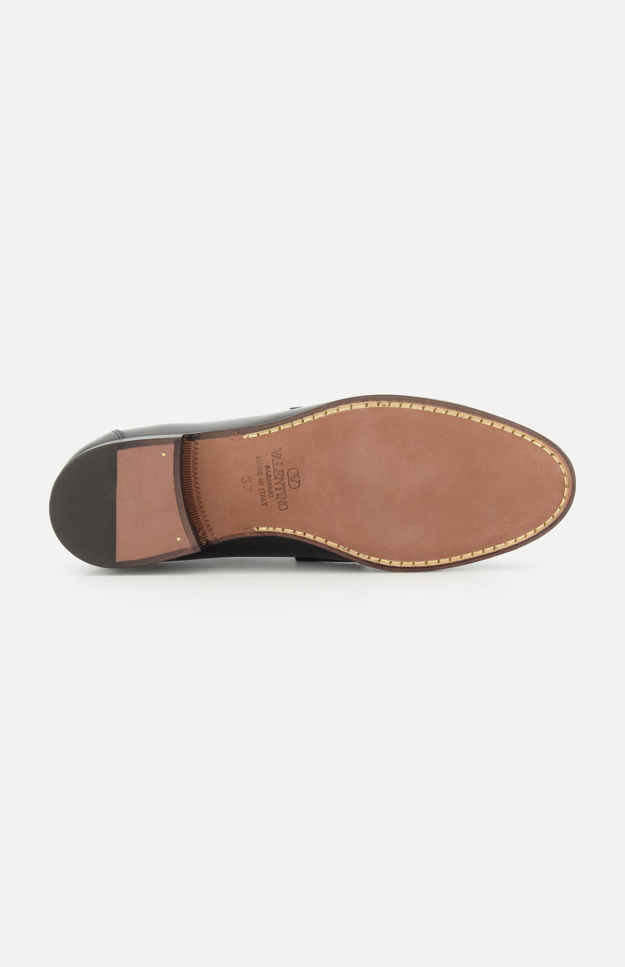 The Valentino Garavani Vaniteux Loafer by VALENTINO GARAVANI features a tan leather sole with visible edge stitching and a black heel.